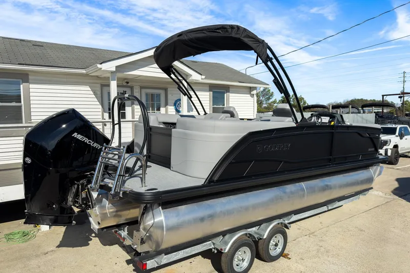 Slide: The Image of 2026 Godfrey Monaco 235 Split Bench pontoon boat on trailer, featuring Mercury engine. - 29