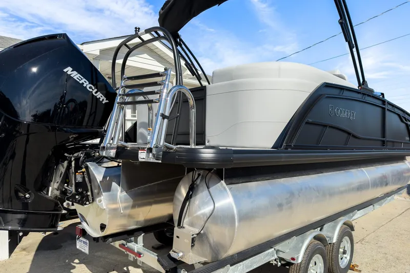 Slide: The Image of 2026 Godfrey Monaco 235 Split Bench pontoon boat with Mercury engine on trailer. - 31