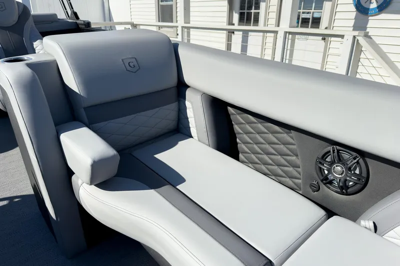 Slide: The Image of 2026 Godfrey Monaco 235 Split Bench interior with luxurious seating and speaker detail. - 38