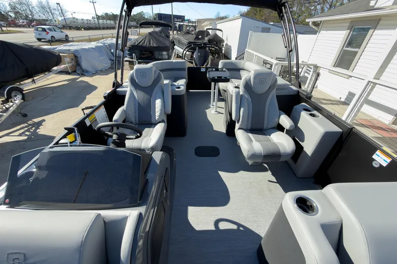 Slide: The Image of 2026 Godfrey Monaco 235 Split Bench boat interior with modern seating and steering console. - 46