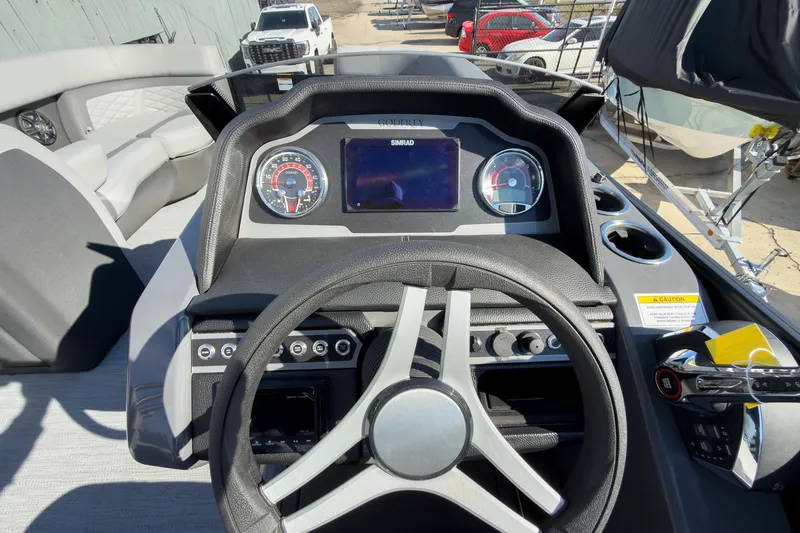 Slide: The Image of 2026 Godfrey Monaco 235 Split Bench dashboard with steering wheel and control panel. - 52