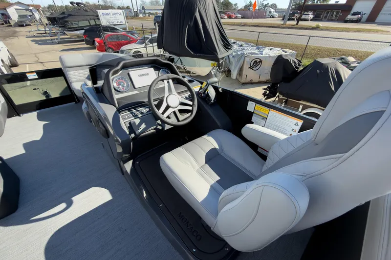 Slide: The Image of 2026 Godfrey Monaco 235 Split Bench boat interior with steering console and seating. - 59