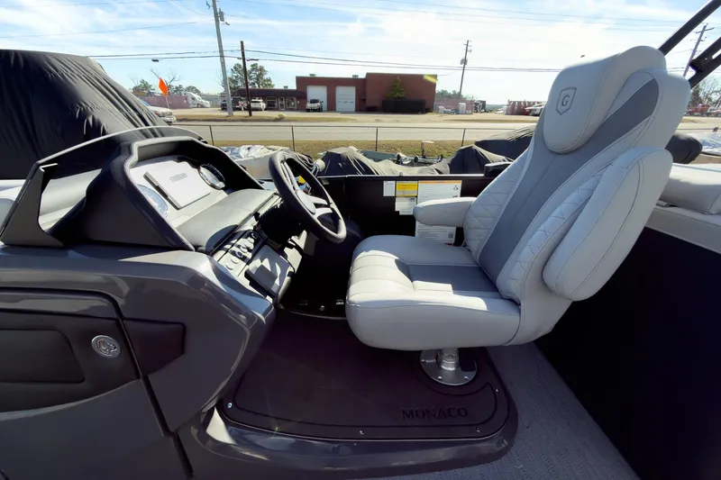Slide: The Image of Captain's seat of 2026 Godfrey Monaco 235 Split Bench boat, featuring modern dashboard and controls. - 60