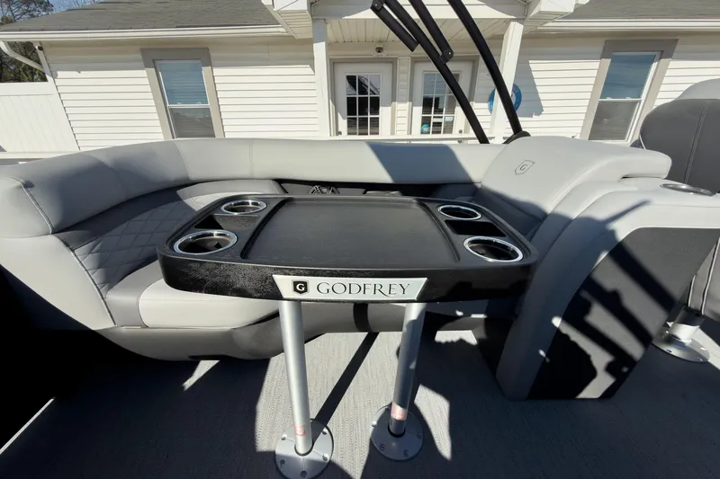 Slide: The Image of 2026 Godfrey Monaco 235 Split Bench interior with table and cup holders. - 66