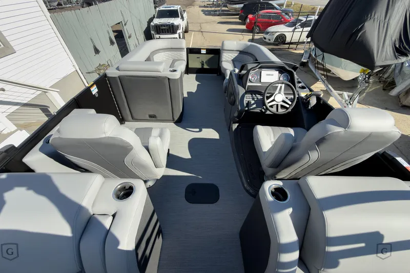 Slide: The Image of 2026 Godfrey Monaco 235 Split Bench boat interior with modern seating and steering console. - 72