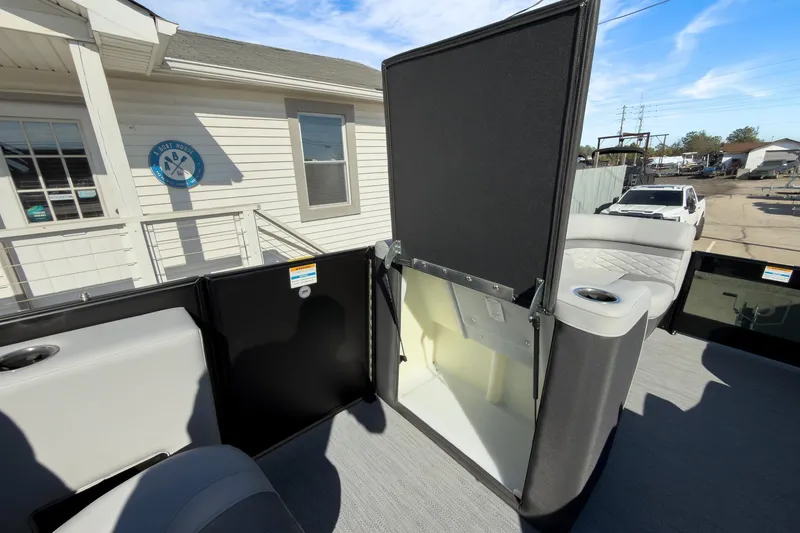 Slide: The Image of 2026 Godfrey Monaco 235 Split Bench boat interior with open storage compartment. - 73