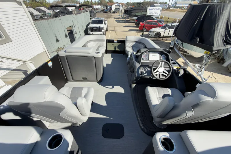 Slide: The Image of 2026 Godfrey Monaco 235 Split Bench boat interior with modern seating and steering console. - 74