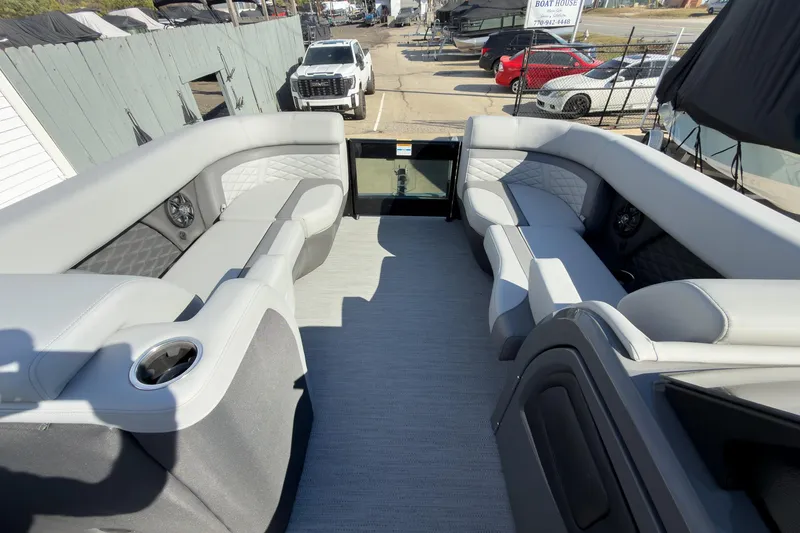 Slide: The Image of 2026 Godfrey Monaco 235 Split Bench boat interior with gray seating and cup holders. - 76