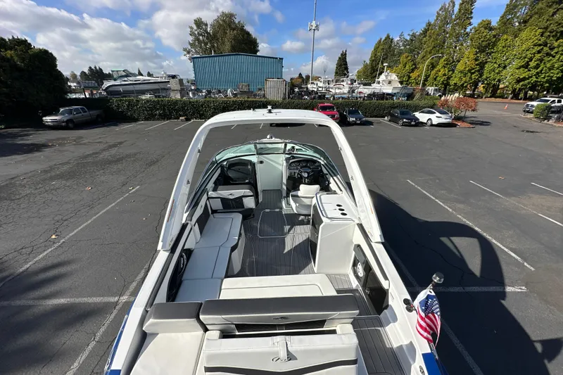 Slide: The Image of 2019 Monterey 278SS Super Sport boat interior with seating and helm, parked outdoors. - 13