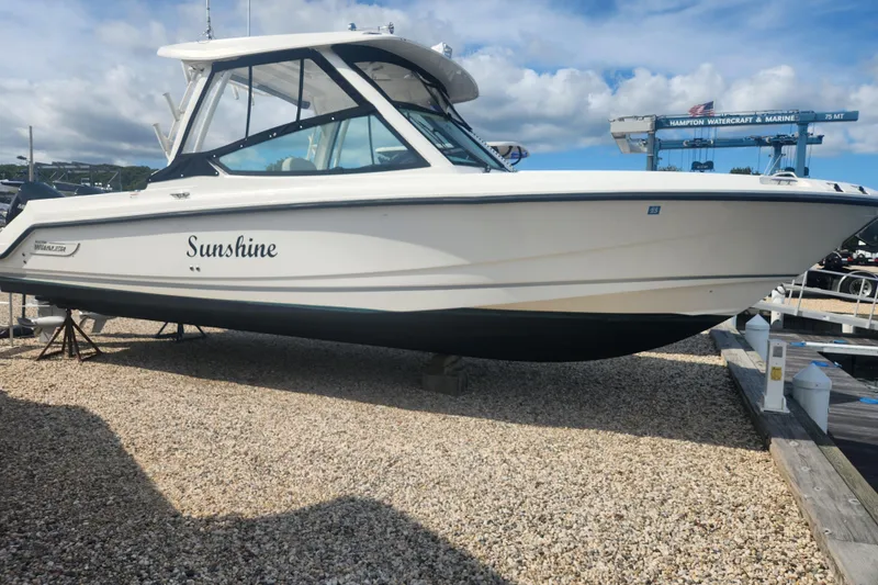 The Image of 2021 Boston Whaler 280 Vantage boat named "Sunshine" on display at a marina. - 0
