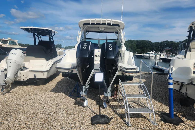 Slide: The Image of 2021 Boston Whaler 280 Vantage with dual 300 HP engines, docked at a marina. - 1
