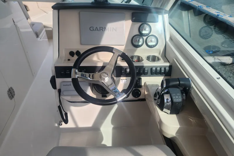 Slide: The Image of 2021 Boston Whaler 280 Vantage helm with Garmin display and controls. - 12