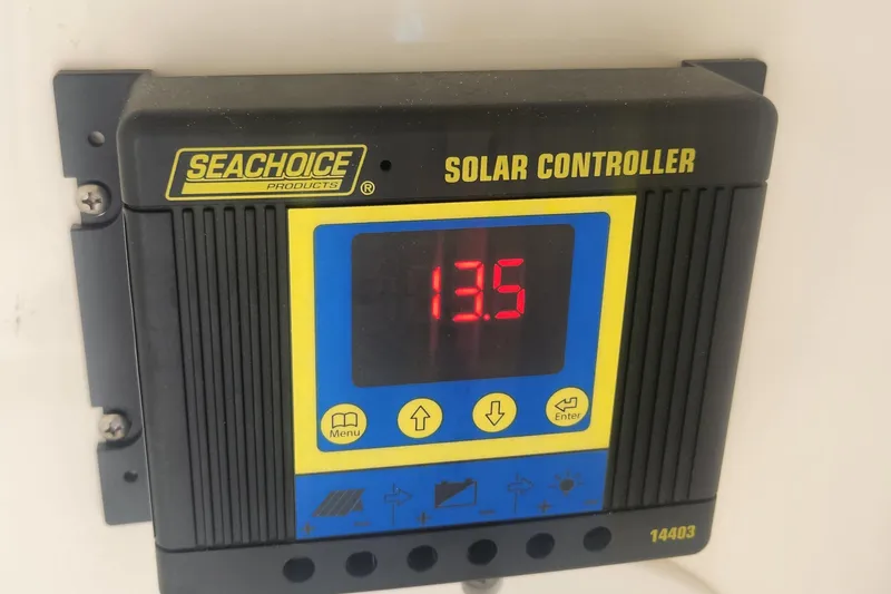 Slide: The Image of Seachoice solar controller displaying 13.5 volts on a Boston Whaler 280 Vantage, 2021 model. - 13