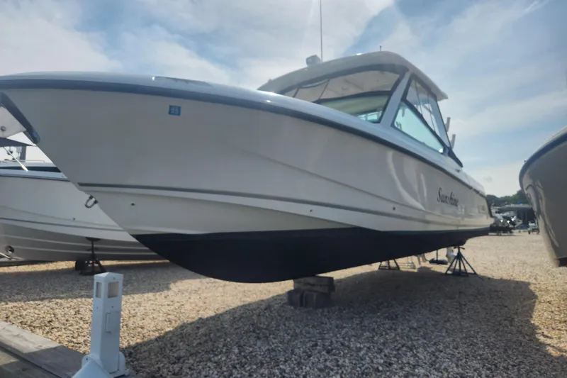 Slide: The Image of 2021 Boston Whaler 280 Vantage boat on display in a sunny outdoor setting. - 19