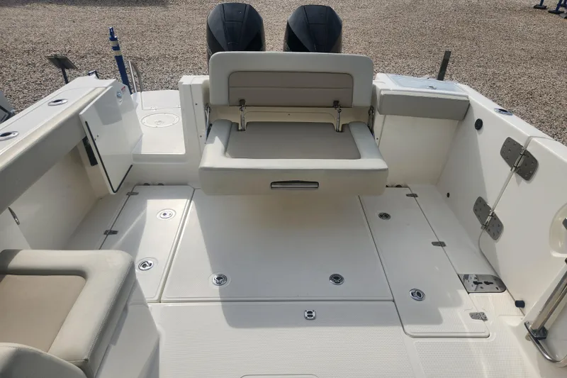 Slide: The Image of 2021 Boston Whaler 280 Vantage boat interior with foldable seating and storage compartments. - 2