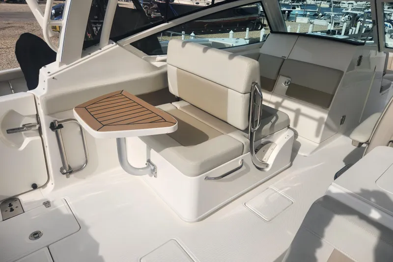 Slide: The Image of 2021 Boston Whaler 280 Vantage interior with seating and table, showcasing luxury boat design. - 8