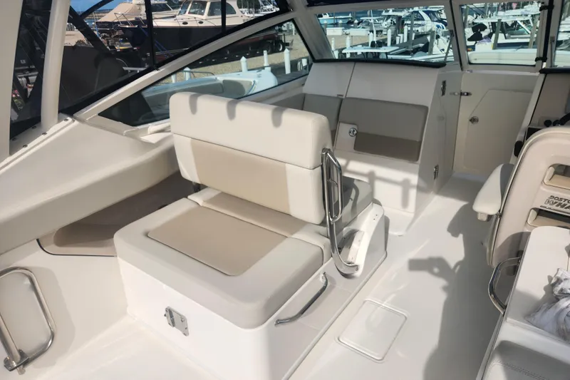Slide: The Image of 2021 Boston Whaler 280 Vantage interior with white seating and sleek design. - 9