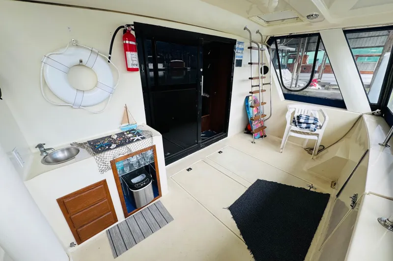 Slide: The Image of 1985 Bluewater 51 Coastal Cruiser interior with seating, life preserver, and nautical decor. - 13
