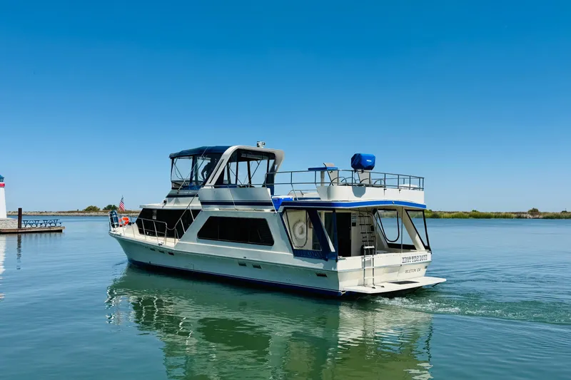 Slide: The Image of 1985 Bluewater 51 Coastal Cruiser yacht on calm water under clear blue sky. - 2