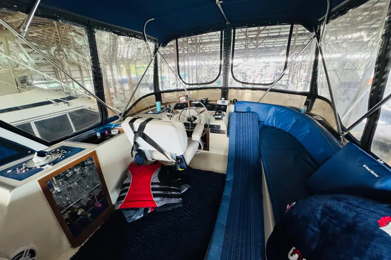 Slide: The Image of Interior of 1985 Bluewater 51 Coastal Cruiser with helm and seating area. - 24