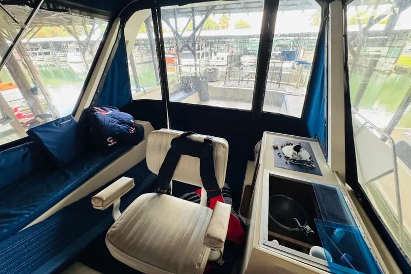 Slide: The Image of Interior of 1985 Bluewater 51 Coastal Cruiser with seating and helm station. - 27