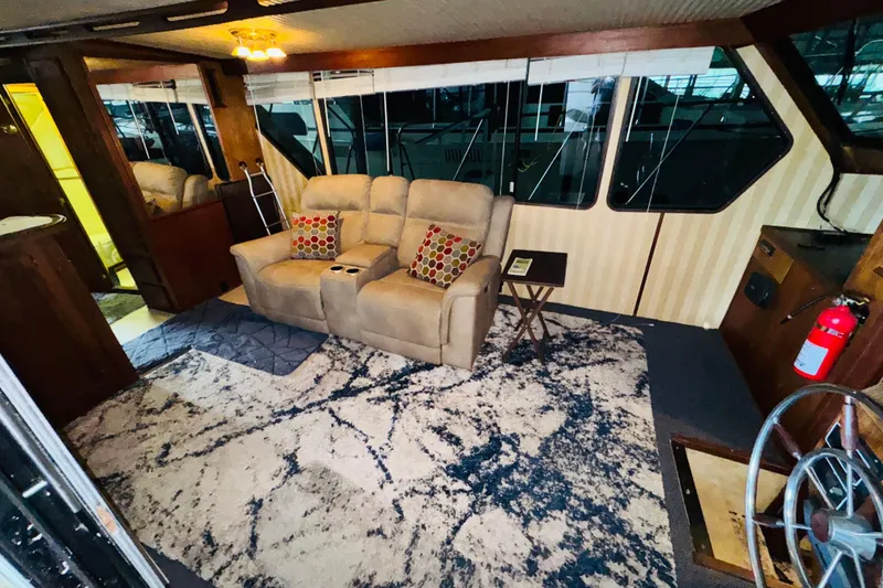 Slide: The Image of Interior of 1985 Bluewater 51 Coastal Cruiser with cozy seating and nautical decor. - 28