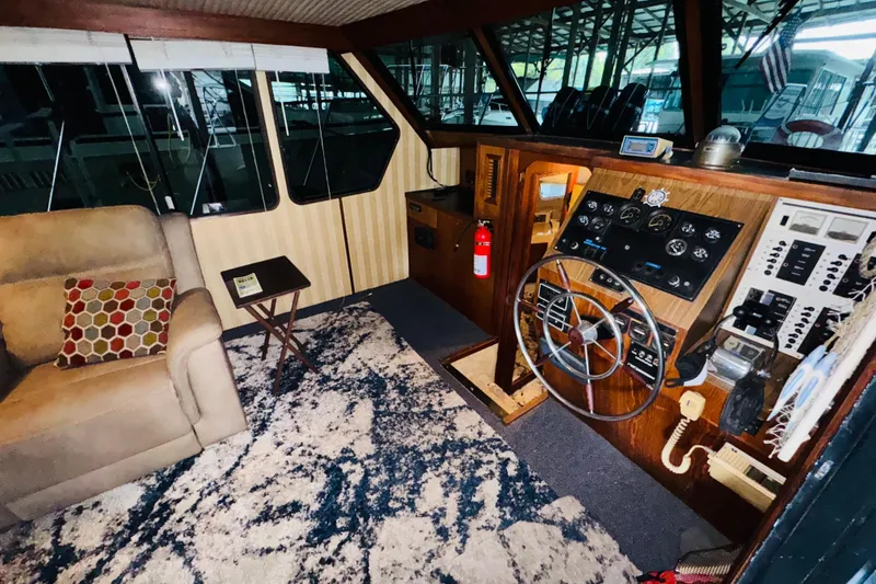 Slide: The Image of Interior of 1985 Bluewater 51 Coastal Cruiser with helm, seating, and nautical decor. - 29