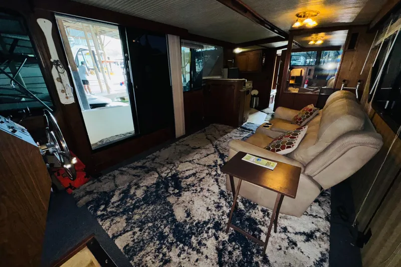 Slide: The Image of Interior of 1985 Bluewater 51 Coastal Cruiser with cozy seating and nautical decor. - 30