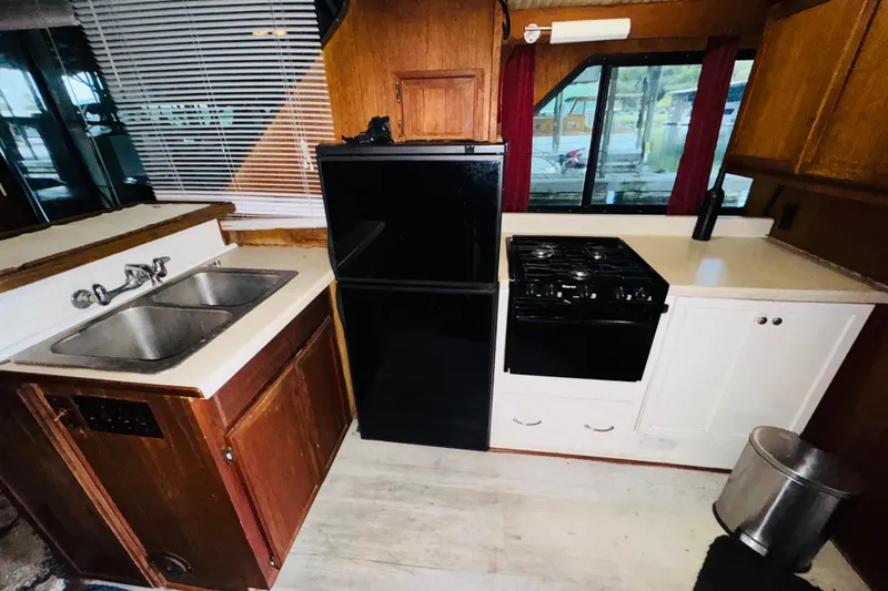 Slide: The Image of 1985 Bluewater 51 Coastal Cruiser kitchen with sink, stove, and refrigerator. - 34