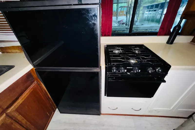 Slide: The Image of Kitchen area of 1985 Bluewater 51 Coastal Cruiser with stove and refrigerator. - 36