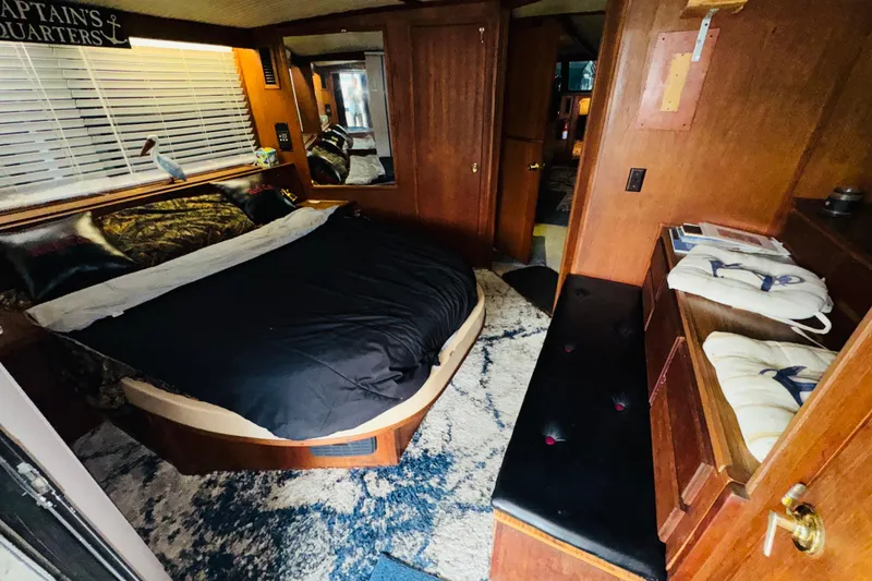 Slide: The Image of Interior of 1985 Bluewater 51 Coastal Cruiser with cozy bedroom and nautical decor. - 39