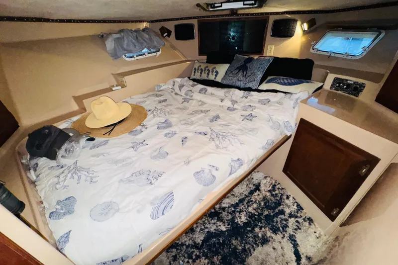 Slide: The Image of Cozy bedroom in 1985 Bluewater 51 Coastal Cruiser with nautical-themed bedding and decor. - 44