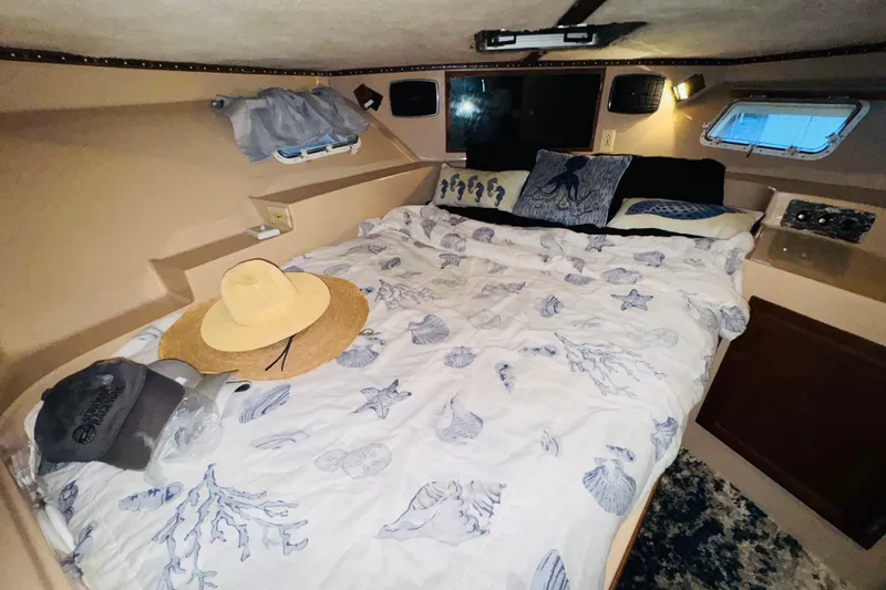 Slide: The Image of Cozy cabin interior of 1985 Bluewater 51 Coastal Cruiser with nautical-themed bedding. - 45