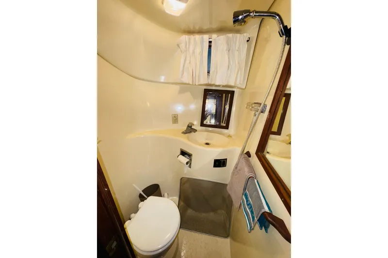 Slide: The Image of 1985 Bluewater 51 Coastal Cruiser bathroom with shower, sink, and toilet. - 46
