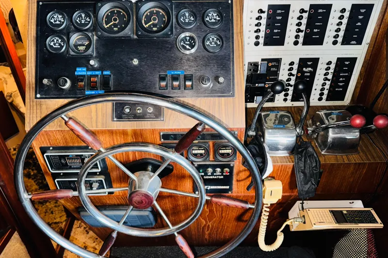 Slide: The Image of 1985 Bluewater 51 Coastal Cruiser helm with gauges, controls, and steering wheel. - 47