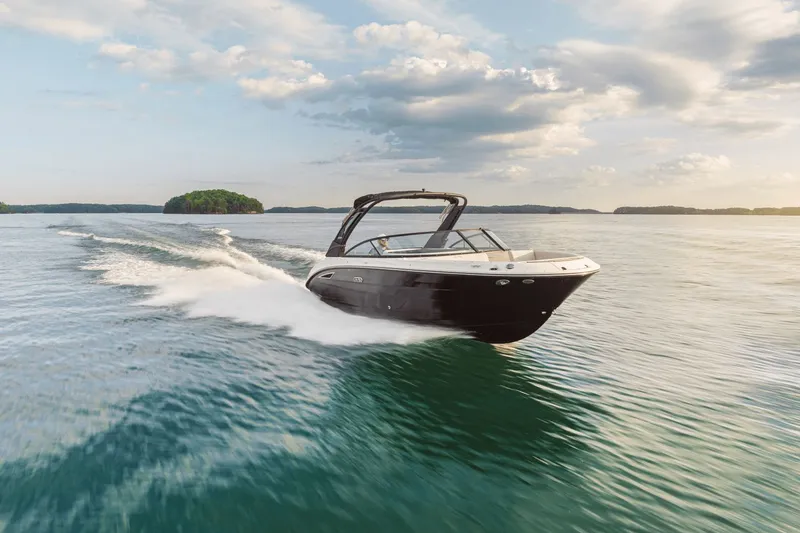 The Image of 2026 Sea Ray SDX 250 boat cruising on calm waters at sunset. - 0