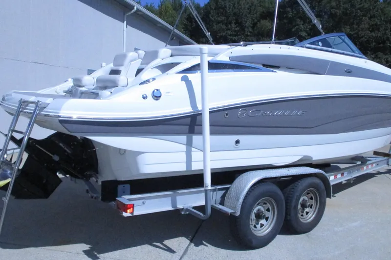Slide: The Image of 2017 Crownline 255 SS boat with white seating and sleek design, docked outdoors. - 3