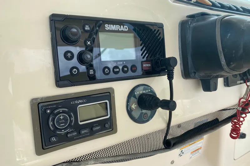 Slide: The Image of Control panel of a 2012 Grady-White Express 360 boat with Simrad and Kenwood systems. - 11
