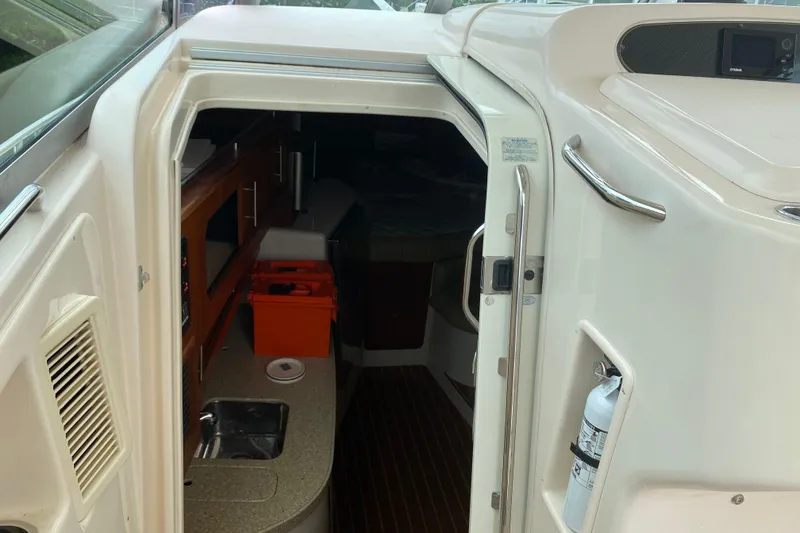 Slide: The Image of 2012 Grady-White Express 360 cabin interior with kitchenette and storage. - 12