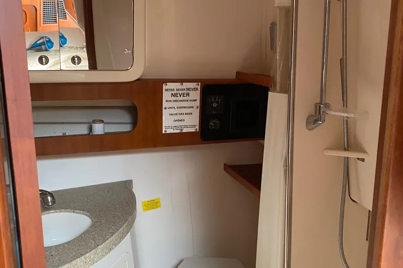 Slide: The Image of 2012 Grady-White Express 360 bathroom with sink, mirror, and shower. - 16