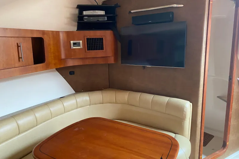 Slide: The Image of Interior of 2012 Grady-White Express 360 boat with seating, table, and TV. - 17