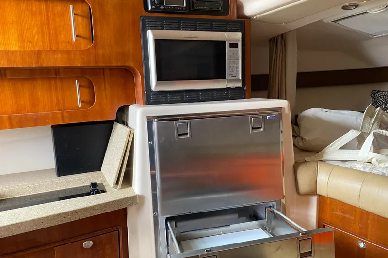 Slide: The Image of 2012 Grady-White Express 360 interior with microwave and storage compartments. - 19