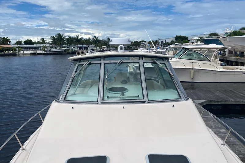 Slide: The Image of 2012 Grady-White Express 360 boat docked at marina, under cloudy sky. - 2