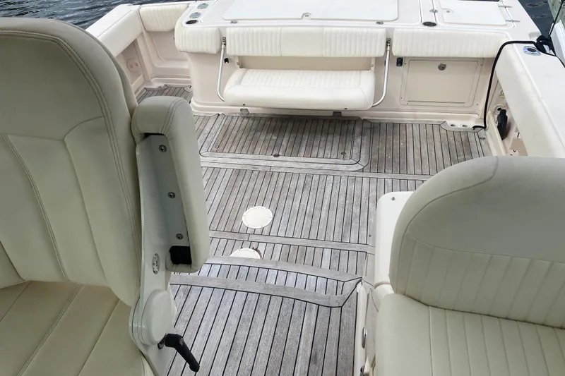 Slide: The Image of 2012 Grady-White Express 360 boat interior with cushioned seating and wooden flooring. - 22