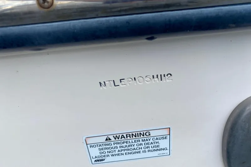 Slide: The Image of Hull identification number on 2012 Grady-White Express 360 boat with safety warning label. - 29