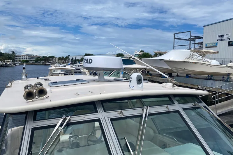 Slide: The Image of 2012 Grady-White Express 360 boat docked, featuring radar and navigation equipment. - 3