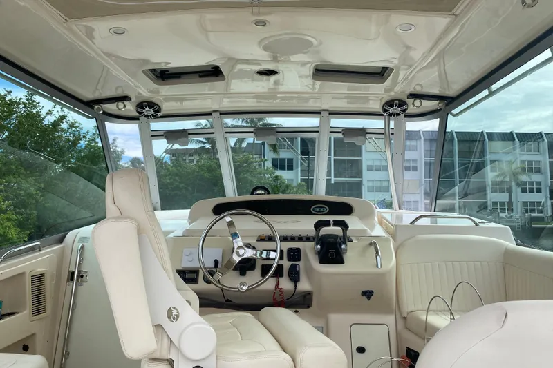 Slide: The Image of Interior of 2012 Grady-White Express 360 boat, featuring steering wheel and control panel. - 6