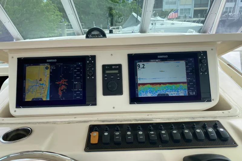 Slide: The Image of Control panel of a 2012 Grady-White Express 360 boat with Simrad displays. - 9