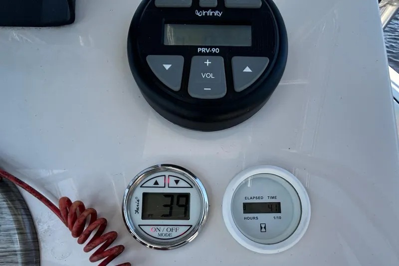 Slide: The Image of 2023 Carolina Skiff 21 LS dashboard with Infinity audio controls and digital displays. - 15