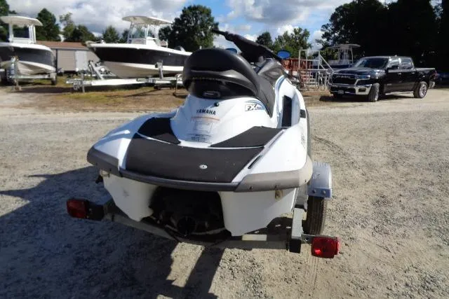 Slide: The Image of 2004 Yamaha WaveRunner FX Cruiser on trailer, parked outdoors with boats and vehicles in background. - 6
